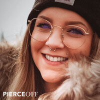 fashionable girl with glasses and warm hat with septum and marilyn piercing