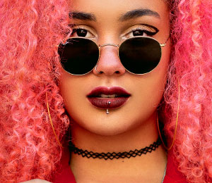 stylish girl wearing sunglasses with vertical labret piercing