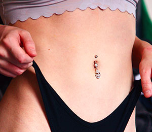 woman wearing a dangling navel belly button bar