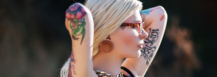 Blonde tattooed girl with stretched ears