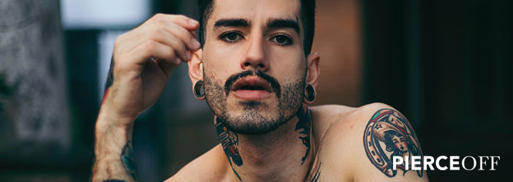 stylish man with stretched ears tunnels