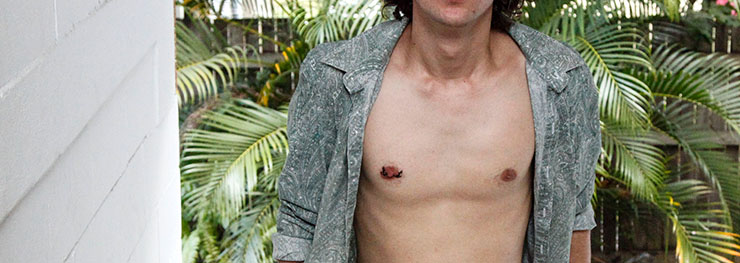 Man with shirt open showing nipple piercing